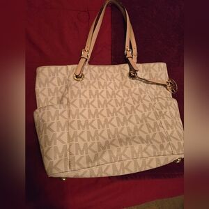 Pretty, cream Michael Kors, jet setter purse. Well loved,but lots of life left.